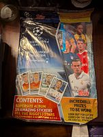 Front of sealed Topps UEFA Champions League sticker album for the 2016/17 season showing players and album details.