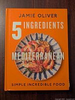 Front cover of the cookbook showing title, author, and a plate of Mediterranean food.