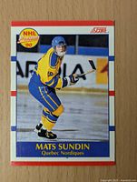 Front of 1990 Score Mats Sundin rookie NHL hockey card showing player in Quebec Nordiques uniform.