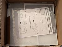 Plastic panels and instruction sheet for Seseno stackable drawer assembly including multiple flat plastic pieces with white framing inside a box.