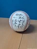 Baseball showing a cluster of signatures including Roberto Alomar and others from the 1992 Toronto Blue Jays team.