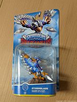 Front of packaged Skylanders SuperChargers Stormblade figure showing character on blue background with branding and character name.