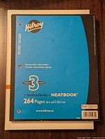 First notebook showing the blue wirebound hardcover with removable ruled sheets and 264 pages, 26.6 cm x 20.3 cm