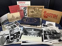Overview of lot showing collection of vintage Boston and Cambridge related books, photo album, photographs, and ephemera materials spread on table.