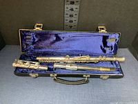 Full view of the Emerson EB 1378 flute disassembled into two pieces inside the blue velvet-lined hard carrying case.