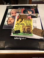 Layered view of Beatles “Let It Be,” Doors Isle of Wight reprint and Beatles logo poster arranged flat