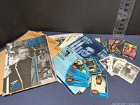 Overview of Star Wars trading cards, fan club packets, and mailers on blue surface