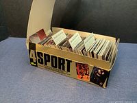Box with over 50 Classic 4Sport trading cards arranged and partially upright in original storage box