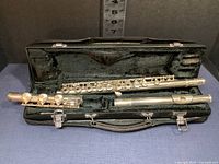 Three-piece Yamaha flute (headjoint, body, footjoint) displayed in open hard shell case