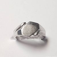 Front view of 10K white gold baby/toe ring showing flat shield-shaped face and band detailing.