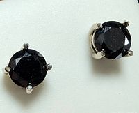 Close-up of both stud earrings on white background