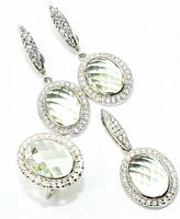 Front view of pair of earrings, pendant, and ring showing faceted green amethyst stones and surrounding cubic zirconia