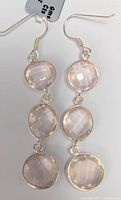 Front view of the silver earrings showing the three faceted rose quartz stones each.