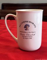 White ceramic commemorative mug with image and text for Queen Elizabeth The Queen Mother's 100th birthday on 4th August 2000
