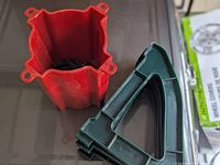 Photo showing the red plastic star-shaped base and green angled support braces for medium size Christmas tree stand.