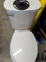 Full view of the white Glacier Bay toilet showing the tank, seat, and lid closed.