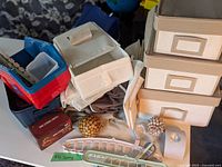 Overview of assorted closet organizers, fabric storage boxes, small containers, clothes hangers, and decorative spheres