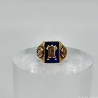 Front view of ring showing rectangular blue inlay with raised gold 'N'