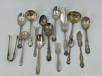 All utensils laid out on white background, top view