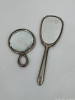 Front view of both hand mirrors on white background