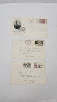 Photo of three First Day Issue covers laid out, showing stamps, postmarks, and addresses