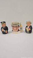 Three Royal Doulton character mugs (Lawyer, Sea Captain, Mr. Pickwick) shown together with clear facial and clothing details.