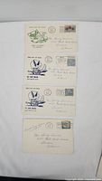 Four first day issue envelopes laid out showing stamps, postmarks, and recipient address.