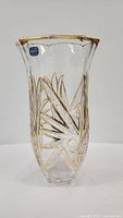 Full view of the clear Bohemia Butterfly vase with gold painted carved flower pattern and gold rim.