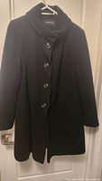 Front view of the black ladies winter coat by London Fog, showing button closure, collar and tailored fit.