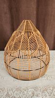 Full view of the natural rattan woven lampshade showing dome-shaped structure and intricate weave pattern.
