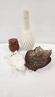 Lot items including beige ceramic vase, brown owl candle, brown owl glass tray, and white owl ornament on a plain background.