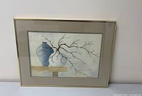 Full view of the framed watercolor painting showing a blue vase, branch, and wooden surface on a muted background.