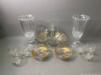 Full view of all items showing arrangement with two tall stem glasses, candy dishes, basket, and stemmed glasses