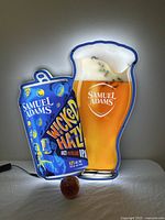 Full view of the illuminated acrylic bar light showing the Samuel Adams Wicked Hazy IPA can and a pint glass filled with beer.