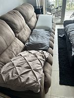 Three pillows arranged on a couch, two with pillowcases, one without, showcasing textures and colors.