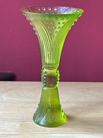 Full view of yellow-green art glass vase with flared top and base, raised bubble dots and linear patterns.