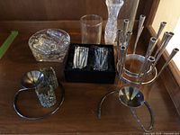 Photo showing the full collection including candleholders, cake servers, utensil rests, and vases