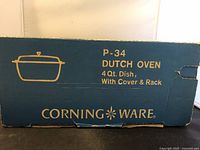Box showing CorningWare branding and P-34 4 Qt Dutch Oven with Cover and Rack description