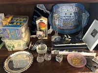 Wide shot of the lot showing the candle tray, glass candlesticks, candle boxes, and other assorted items