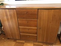 Front view of the wooden sideboard showing 4 drawers in the center and 2 cabinet doors on sides.