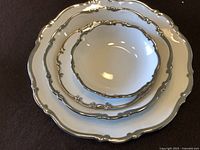 Top view of three stacked plates showing scalloped edges with platinum trim