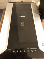 Top view of Canon CanoScan 8800F scanner showing control buttons and brand labels