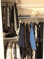 Wide view of hanging tops, jackets, and blazers in neutral and dark colors including brown, leopard, black, blue, and floral prints