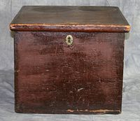 Front exterior of dark brown varnished wooden hatbox