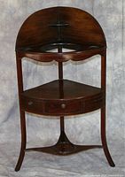 Full view of empty corner shelf washtub stand with scalloped front, circular hole and curved legs