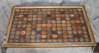 Full top-down shot of the rectangular wood sample board showing 81 wood samples arranged in a grid within individual compartments in aged wooden frame.
