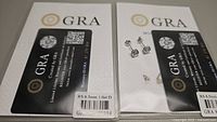 Photo showing GRA certification card and two moissanite stud earrings on display with packaging