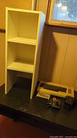 Overview of shelf, VIC-20 unit with power supply, joystick and cartridge on table