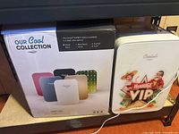 Cooluli Infinity-10LG mini fridge with box showing color options and collection branding.