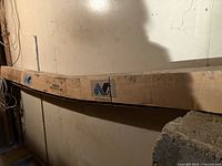 Long rectangular cardboard box containing polyethylene greenhouse film, marked with AT Plastics Inc. logo.